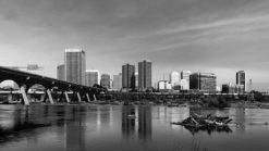 black and white Richmond photo with building reflecting in the james river