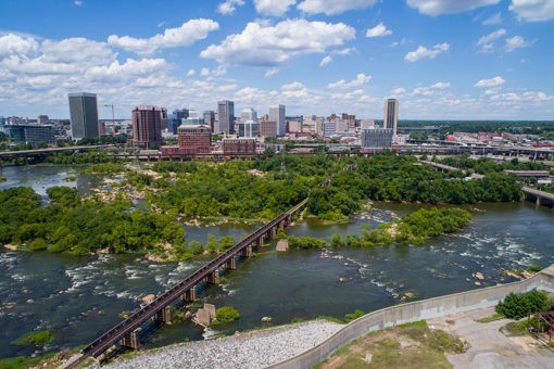 aerial photo of richmond virginia and train track going across the james river