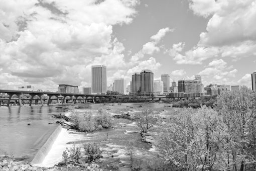 richmond virginia skyline with james river in the foreground and clouds in the sky