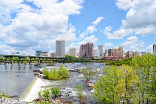 richmond virginia skyline with james river and greenery in the foreground